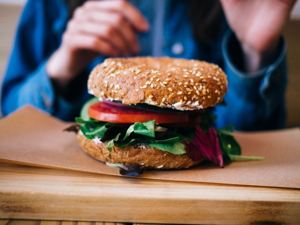 veggie burger with a sesame bun on a wooden table