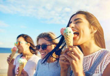 Three young woman eating ice cream cones