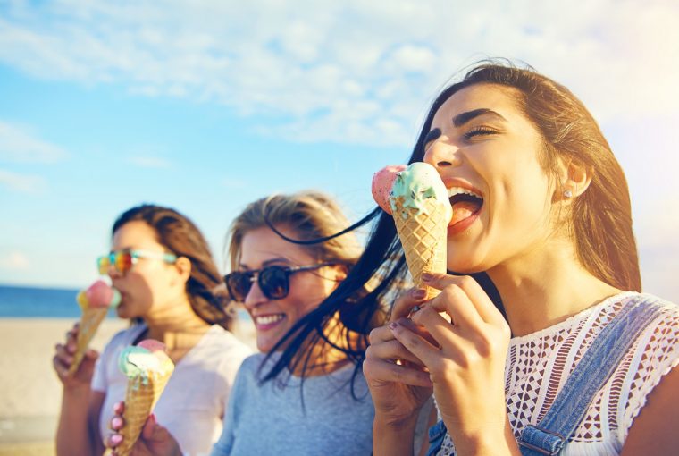 Three young woman eating ice cream cones