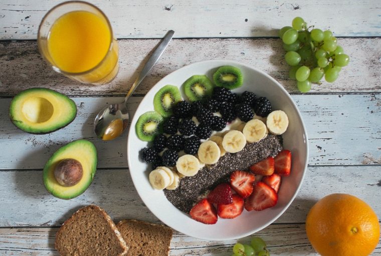 A fruit bowl with different kinds of fruit and berries