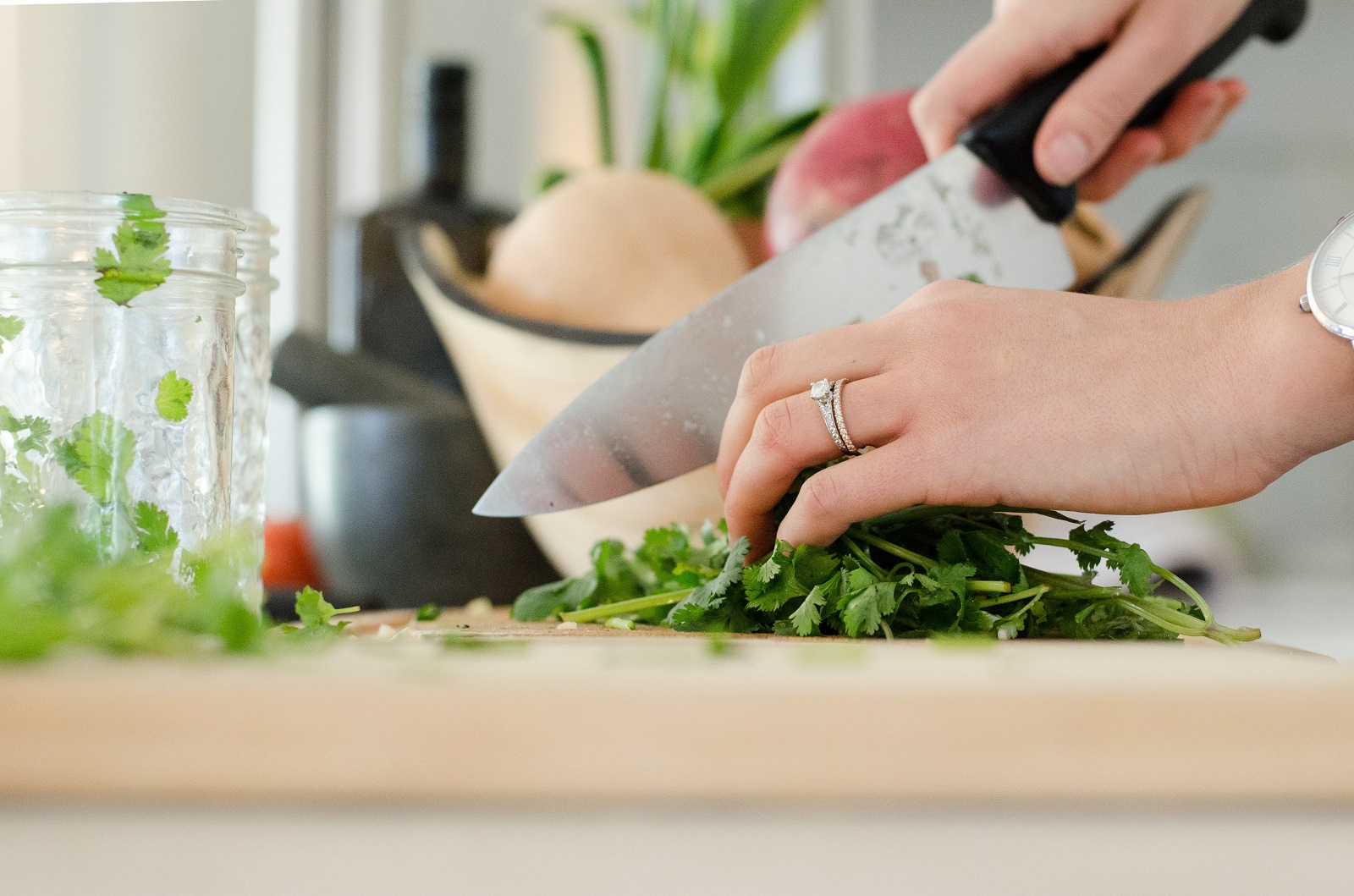 woman chopping fresh herbs