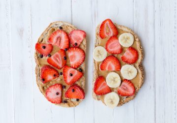 peanut butter toasts with strawberries and cacao nibs