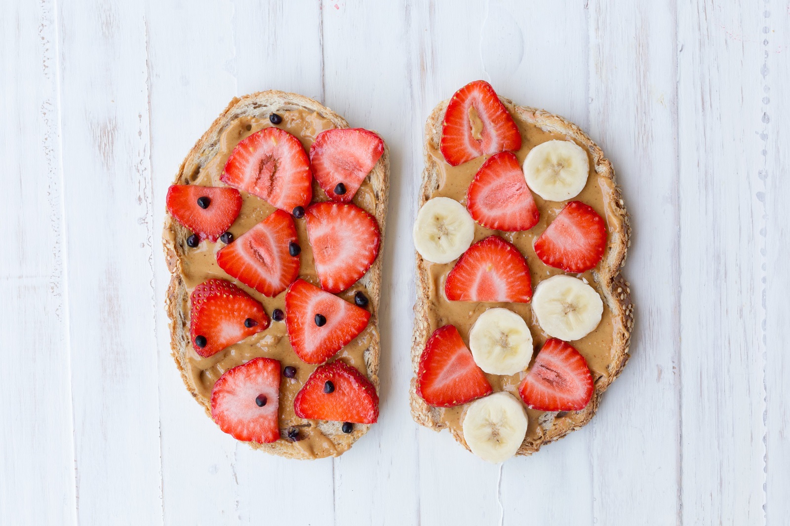peanut butter toasts with strawberries and cacao nibs