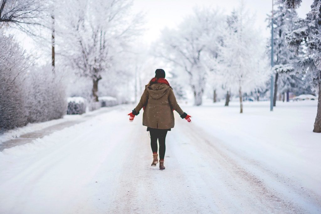woman walking in snowy street