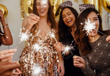 group of women with sparklers celebrating New Year's