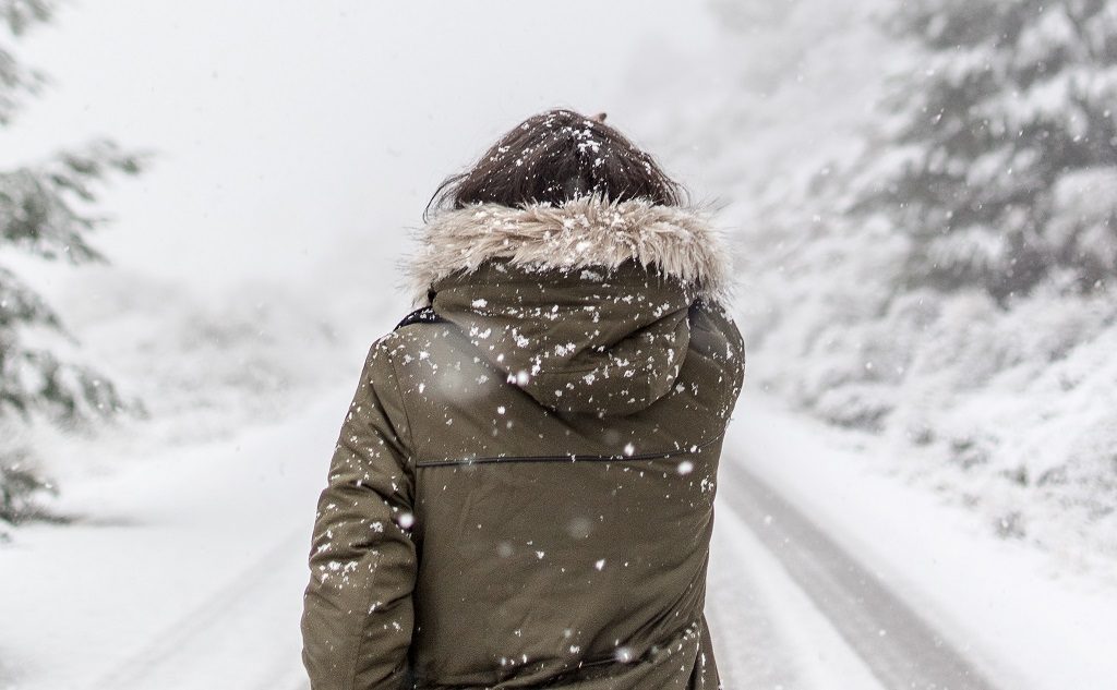 woman walking down snowy path