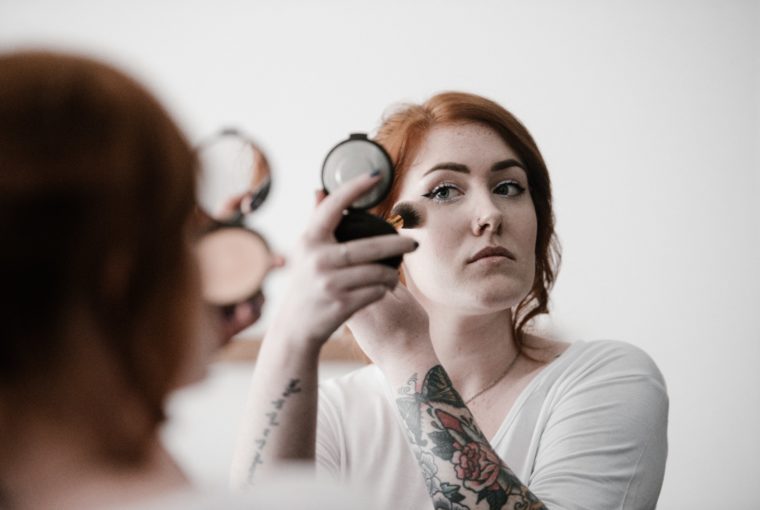 woman applying makeup