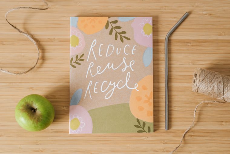 common items that can be reused and a notebook that says reduce, reuse, recycle